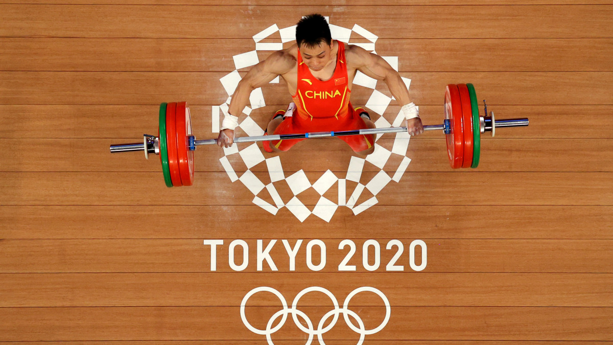 TOKYO, JAPAN - JULY 25: Lijun Chen of Team China competes during the Weightlifting - Mens 67kg Group A on day two of the Tokyo 2020 Olympic Games at Tokyo International Forum on July 25, 2021 in Tokyo, Japan. (Photo by Chris Graythen/Getty Images)