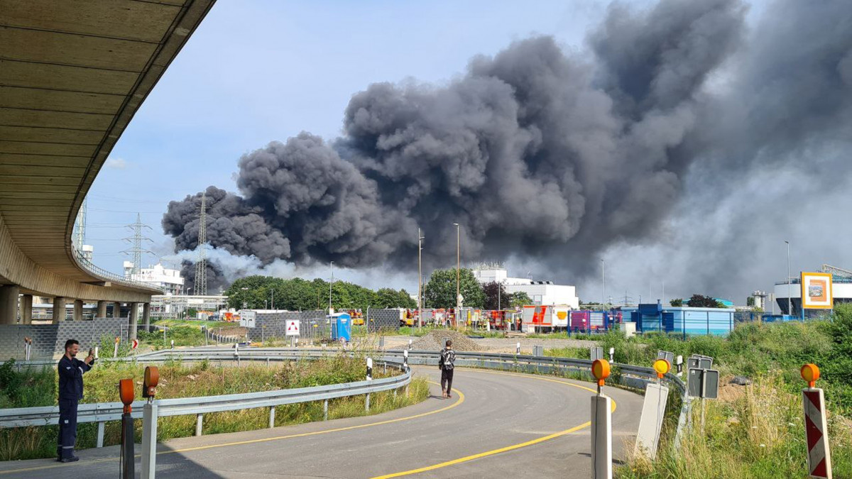 27 July 2021, North Rhine-Westphalia, Leverkusen: A dark cloud of smoke rises above the chemical park. Firefighters from the site fire department are on duty. Photo: Mirko Wolf/dpa (Photo by Mirko Wolf/picture alliance via Getty Images)