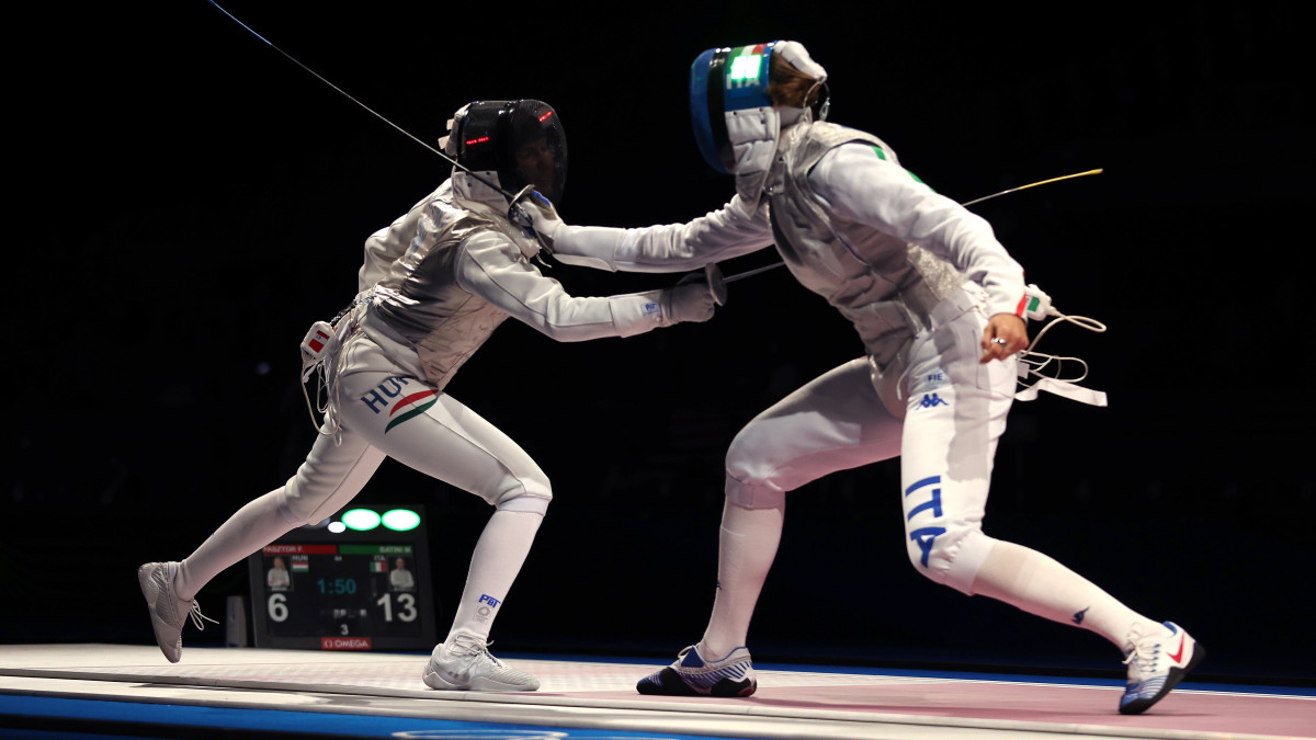 CHIBA, JAPAN - JULY 29: Flora Pasztor of Team Hungary, left, competes against Martina Batini of Team Italy Womens Foil Team Quarterfinal on day six of the Tokyo 2020 Olympic Games at Makuhari Messe Hall on July 29, 2021 in Chiba, Japan. (Photo by Jamie Squire/Getty Images)