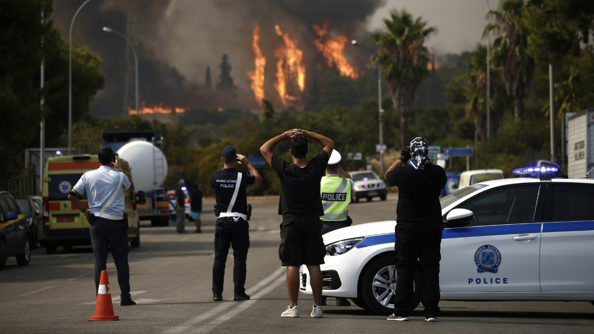 Lángol a növényzet Athén északkeleti külvárosa, Varibobi környékén 2021. augusztus 3-án. 350 tűzoltó, 70 járművel, öt helikopterrel és kilenc repülővel próbálja oltani a tüzet, amely egyelőre nem fenyeget lakóépületeket, ipari létesítményeket, de vastag füstfelhővel borítja be a város légterének egy részét. Görögországban, ahol 42 Celsius-fokos hőség tombol, több mint száz helyen kapott lángra a növényzet az utóbbi napokban.