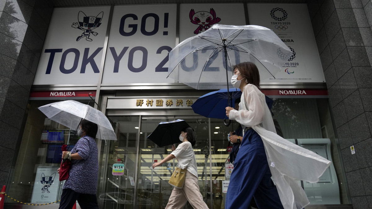 Esernyőt tartó emberek Tokióban 2021. július 27-én, a világméretű koronavírus-járvány miatt elhalasztott 2020-as tokiói nyári olimpia idején. A japán fővárosban az eddigi hőséget követően elkezdett esni az eső, és 10 Celsius-fokkal csökkent a hőmérséklet.