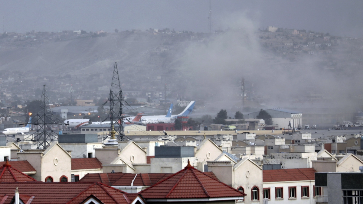 Füst száll a magasba egy robbanást követően a kabuli Hamid Karzai Nemzetközi Repülőtéren 2021. augusztus 26-án.