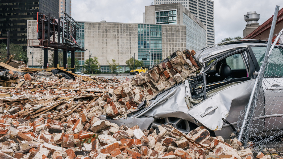 NEW ORLEANS, LOUISIANA - AUGUST 30: A car is seen under rubble after a building was destroyed by Hurricane Ida on August 30, 2021 in New Orleans, Louisiana. Ida made landfall as a Category 4 hurricane on August 29 in Louisiana and brought flooding and wind damage along the Gulf Coast.  (Photo by Brandon Bell/Getty Images)