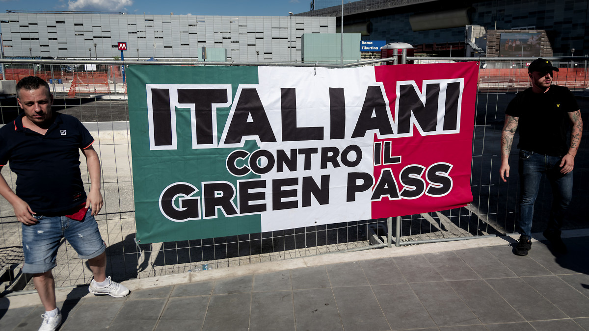 ROME, ITALY - SEPTEMBER 01:: Far right party Forza Nuova demonstrators display a banner against the Green Pass near the entrance to the Tiburtina railway station, where the garrison against the Green Card had been called  which from today is also necessary to travel on long-distance trains, planes and ships on September 1, 2021 in Rome, Italy. The rally had been called in many Italian cities to block the railway stations to protest against the Green Pass but failed due to the few demonstrators. Italys so-called Green Pass has been extended as of September 1 to transport and education sectors. (Photo by Stefano Montesi - Corbis/Corbis via Getty Images)
