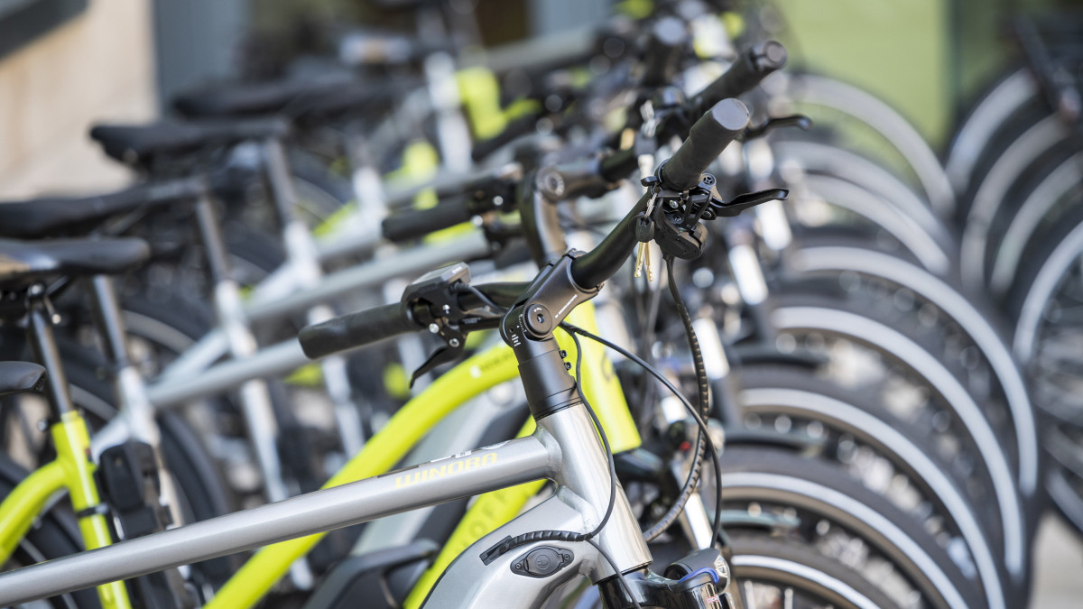 Elektromos rásegítésű kerékpárok az MVM Csoport Szentendrei úti székházában 2021. augusztus 10-én. A társaságcsoport a Hellovelo Zrt.-vel közösen elindította munkavállalói számára pilot projektjét, amelynek keretében kezdetben ötven elektromos bicikli bevonásával vizsgálja a kerékpárok munkáltatói juttatásként való alkalmazhatóságát, arra ösztönözve a dolgozókat, hogy minél többen járjanak kerékpárral munkahelyükre.