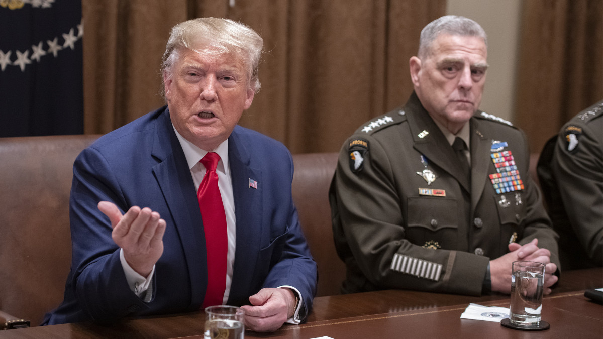 U.S. President Donald Trump speaks to members of the media, as Mark Milley, chairman of the joint chiefs of staff, right, listens during a briefing with senior military leaders in Washington, D.C., U.S., on Monday, Oct. 7, 2019. Trump appeared to backpedal after giving Turkey a green light to attack U.S.-allied Kurdish forces in northern Syria, warning Ankara in a tweet that he would totally destroy and obliterate the countrys economy if it takes unspecified off limits actions. Photographer: Ron Sachs/CNP/Bloomberg via Getty Images