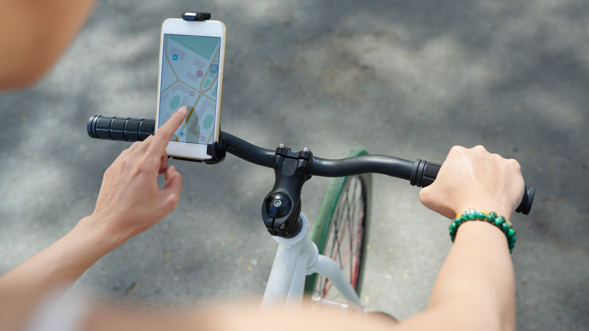 Woman using navigator application on her phone when riding bicycle