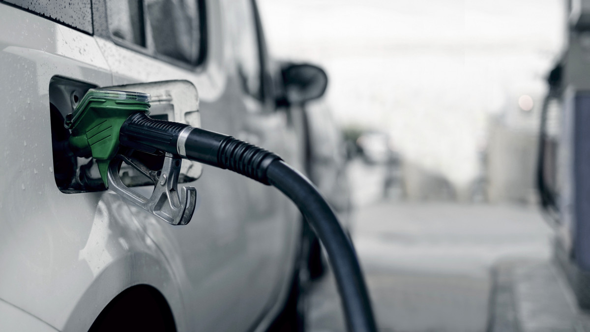 Pumping gasoline fuel in car.