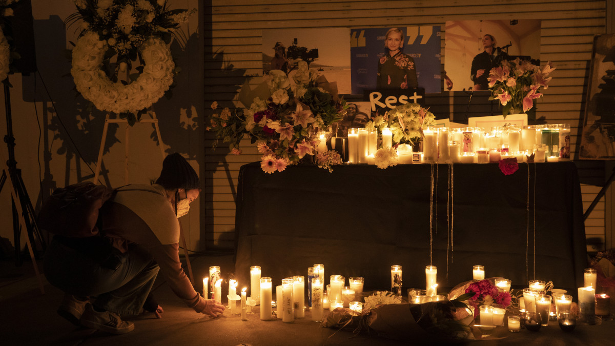 BURBANK, CA - OCTOBER 24: Jamie Frazer (cq) who works in costumes and is a member of IATSE Local 705, places a candle during a vigil on Sunday, Oct. 24, 2021 at IATSE Local 80 in Burbank, CA for director of photography Halyna Hutchins who was fatally shot accidentally by Alec Baldwin on the Rust movie set at Bonanza Creek Ranch outside Santa Fe, N.M., on Thursday, October 21, 2021. The movies director Joel Souza also was injured in the accident. The IATSE Local 80 represents motion picture grips, crafts service, marine, first aid employees and warehouse workers according to its website. Photographed in IATSE Local 80 on  in Burbank, CA. (Myung J. Chun / Los Angeles Times via Getty Images)