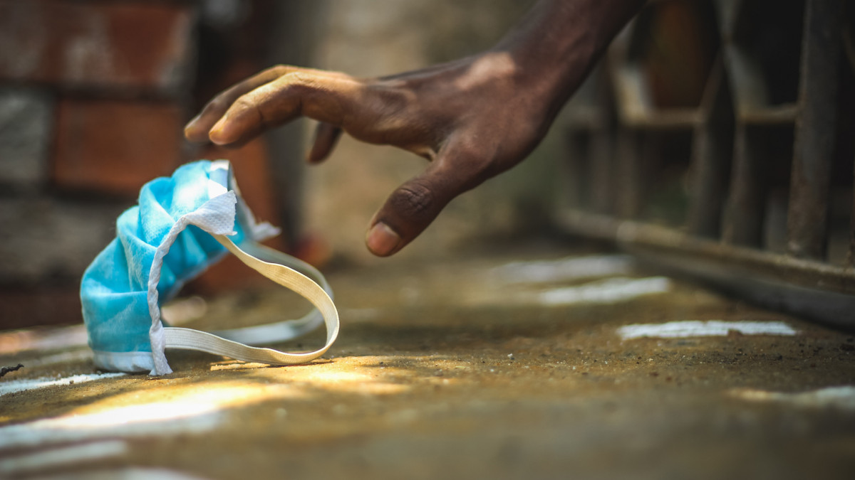 Protection Mask taking on men hand against corona virus,infection mask,healthcare concept. Poverty people taking blue face mask on their hand