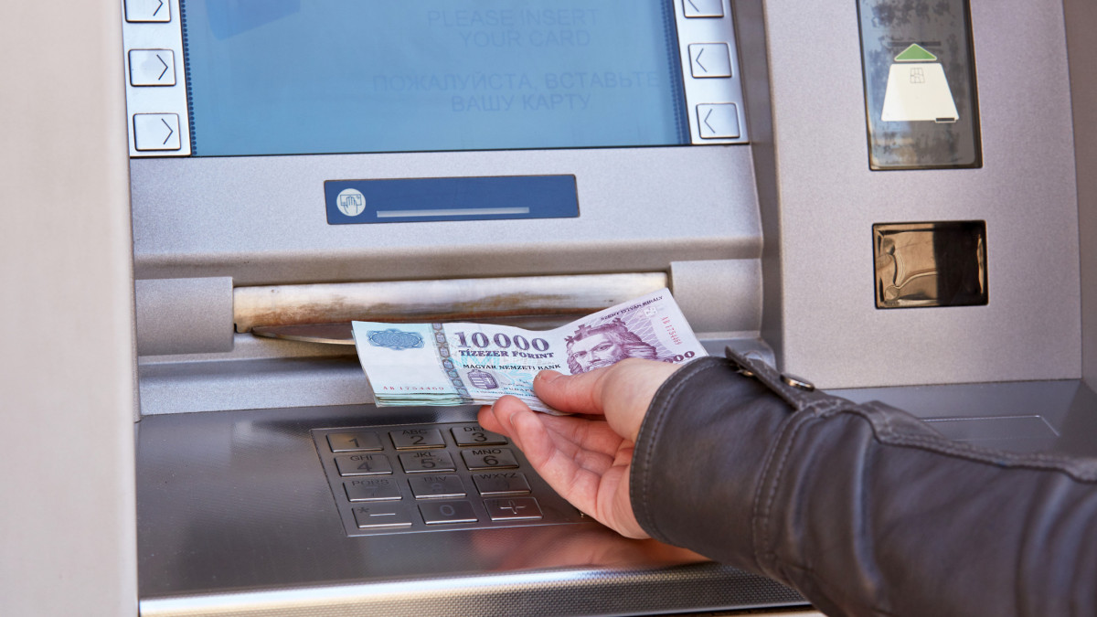 woman hand take out forint banknotes from atm