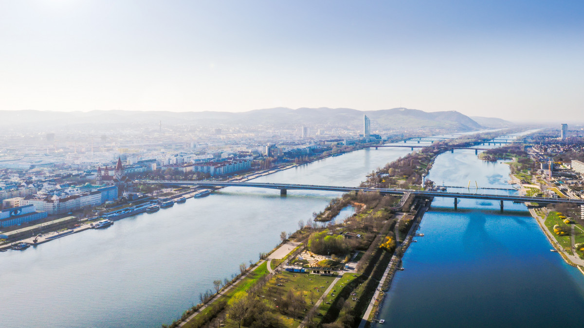 Danube and Vienna city aerial panoramic view. Donaustadt district and danube island during spring and summer.
