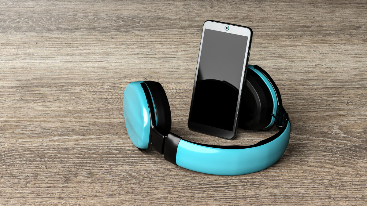 smartphone with bluetooth headphone on wooden desk - 3D rendering