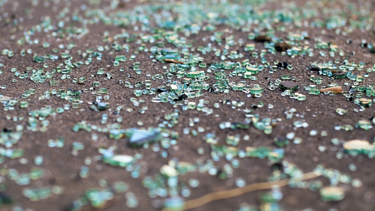 Shards of car glass on the asphalt road.