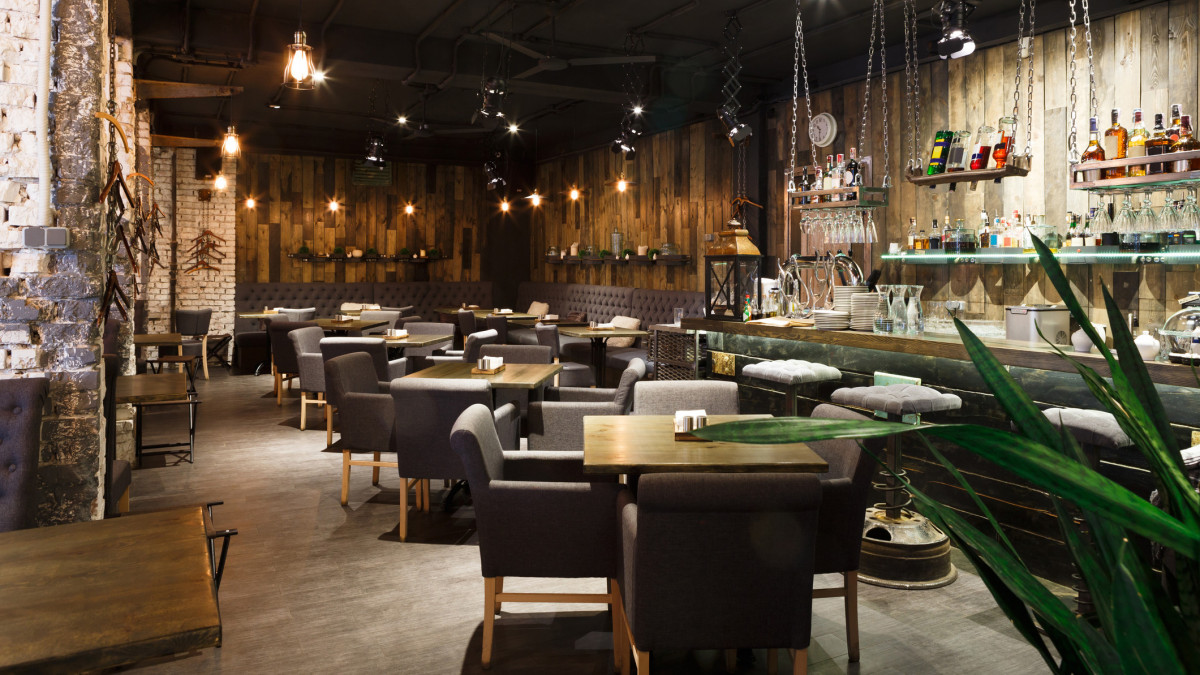 Interior of cozy restaurant. Contemporary design in loft style, modern dining place and bar counter, copy space