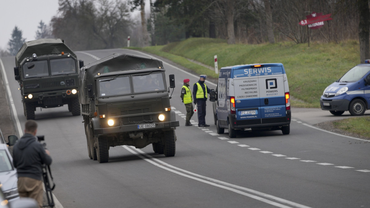 Lengyel katonai teherautók a fehérorosz határ közelében felállított egyik ellenőrző pontnál, Kuznica térségében 2021. november 16-án. A határ túloldalán több ezer migráns gyűlt össze, hogy a határon áttörve bejusson Lengyelországba és az Európai Unióba.