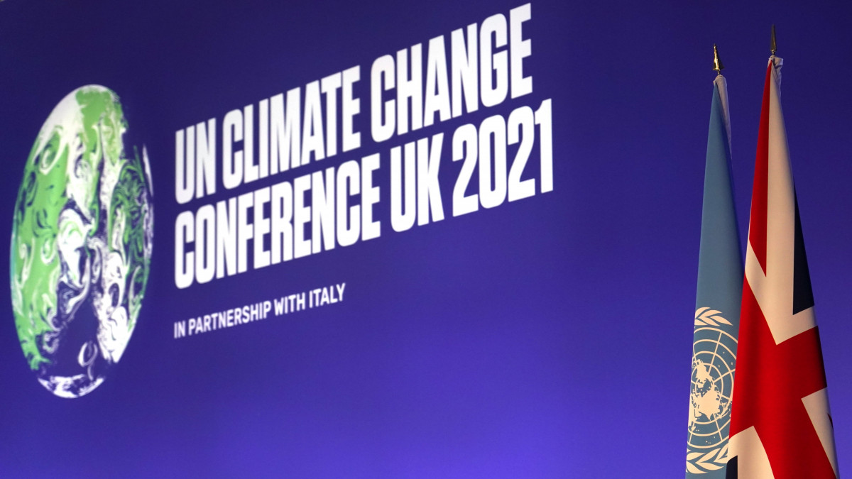 Az Egyesült Nemzetek Szervezetének (ENSZ) zászlaja és a brit zászló az ENSZ 26. klímakonferenciájának (COP26) megnyitója előtt Glasgow-ban 2021. október 31-én. A november 12-ig tartó konferencia célja, hogy a a november 1-jén érkező állam- és kormányfők elkötelezzék magukat amellett, hogy a globális felmelegedés mértéke az iparosodás előtti értékhez képest ne haladja meg a 1,5 Celsius-fokot.