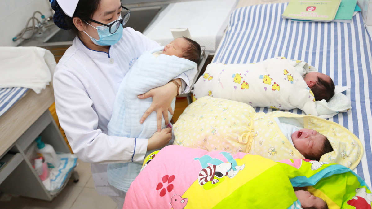 XIANGYANG, CHINA - FEBRUARY 12: A nurse takes care of newborn babies at a hospital on February 12, 2021 in Xiangyang, Hubei Province of China. (Photo by Gong Bo/VCG via Getty Images)