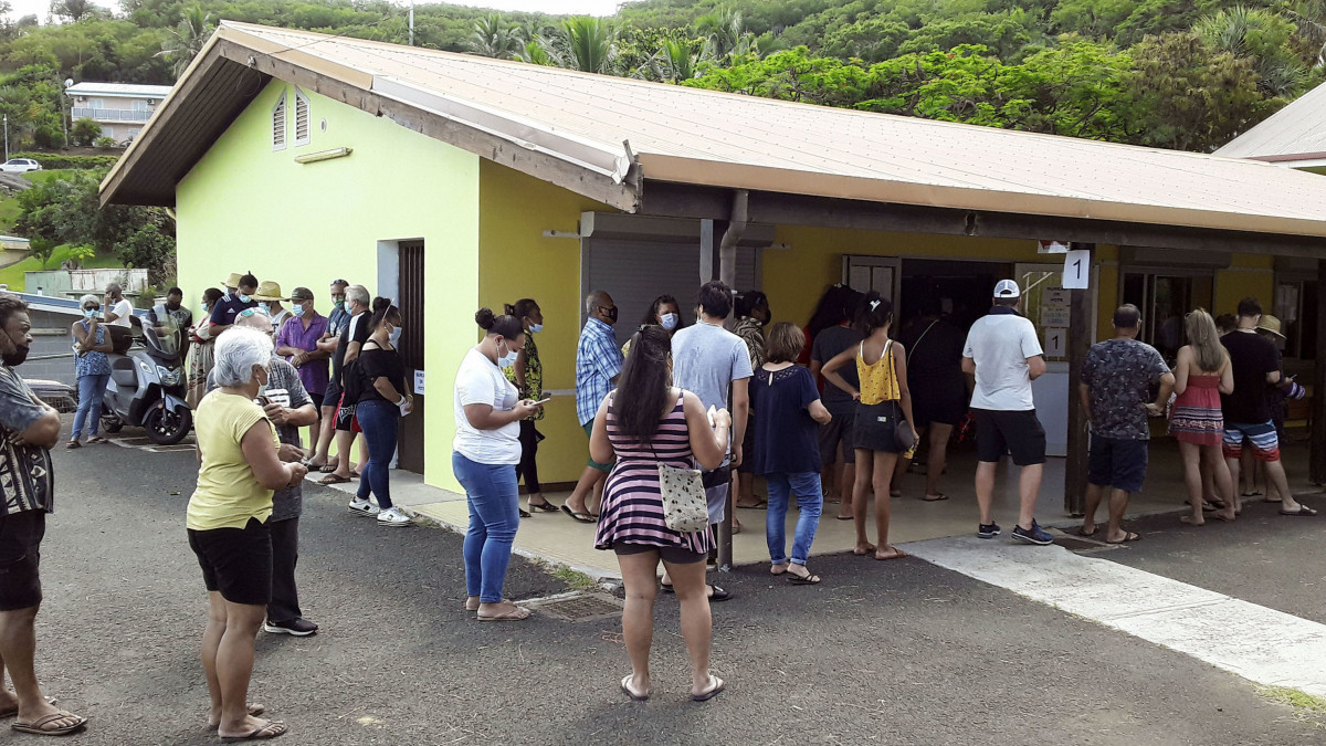 People gather at a polling station in Noumea, the capital of New Caledonia, a French territory in the South Pacific, on Dec. 12, 2021, for a third and final referendum on independence from France. (Photo by Kyodo News via Getty Images)