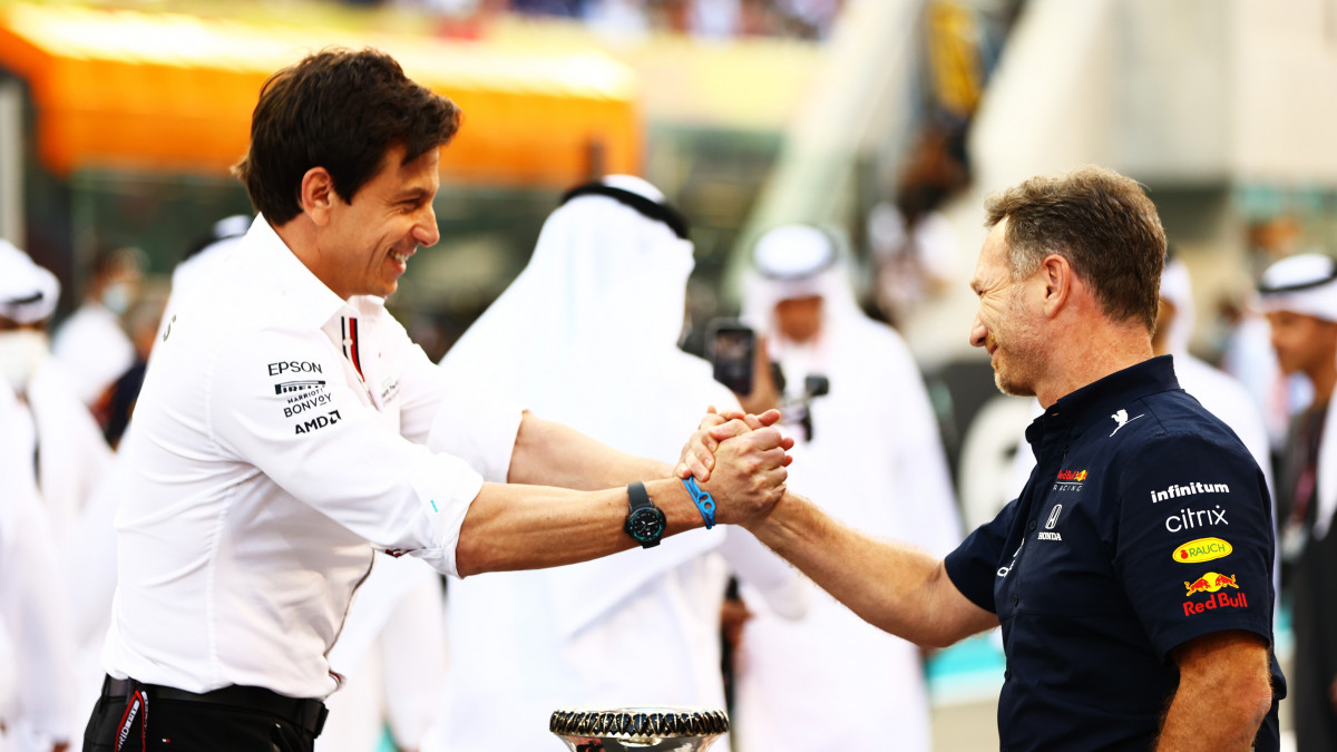 ABU DHABI, UNITED ARAB EMIRATES - DECEMBER 12: Mercedes GP Executive Director Toto Wolff and Red Bull Racing Team Principal Christian Horner shake hands on the grid before the F1 Grand Prix of Abu Dhabi at Yas Marina Circuit on December 12, 2021 in Abu Dhabi, United Arab Emirates. (Photo by Dan Istitene - Formula 1/Formula 1 via Getty Images)
