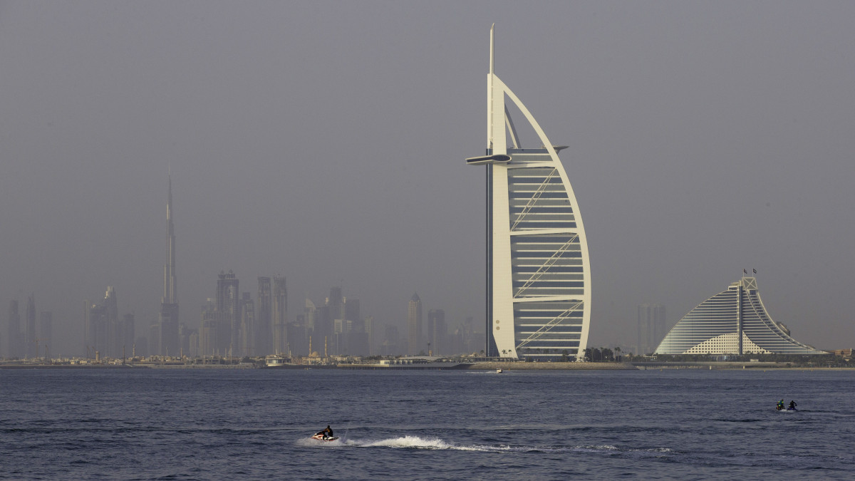 Jet skiers pass the Burj Al-Arab hotel, second right, and Jumeirah Beach Hotel, right, in Dubai, United Arab Emirates, on Friday, June 15, 2018. Since the 1970s, Dubai has invested heavily in construction and infrastructure, creating a global center for finance, real estate and tourism. Photographer: Christopher Pike/Bloomberg via Getty Images