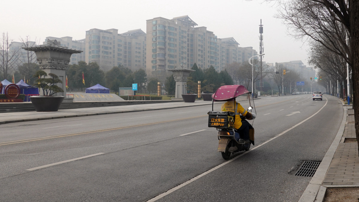 XIAN, CHINA - JANUARY 5, 2022 - Courier and cleaning staff ride on a street in Xi an, Shaanxi Province, China, Jan 5, 2022. (Photo credit should read Yi Qing / Costfoto/Future Publishing via Getty Images)