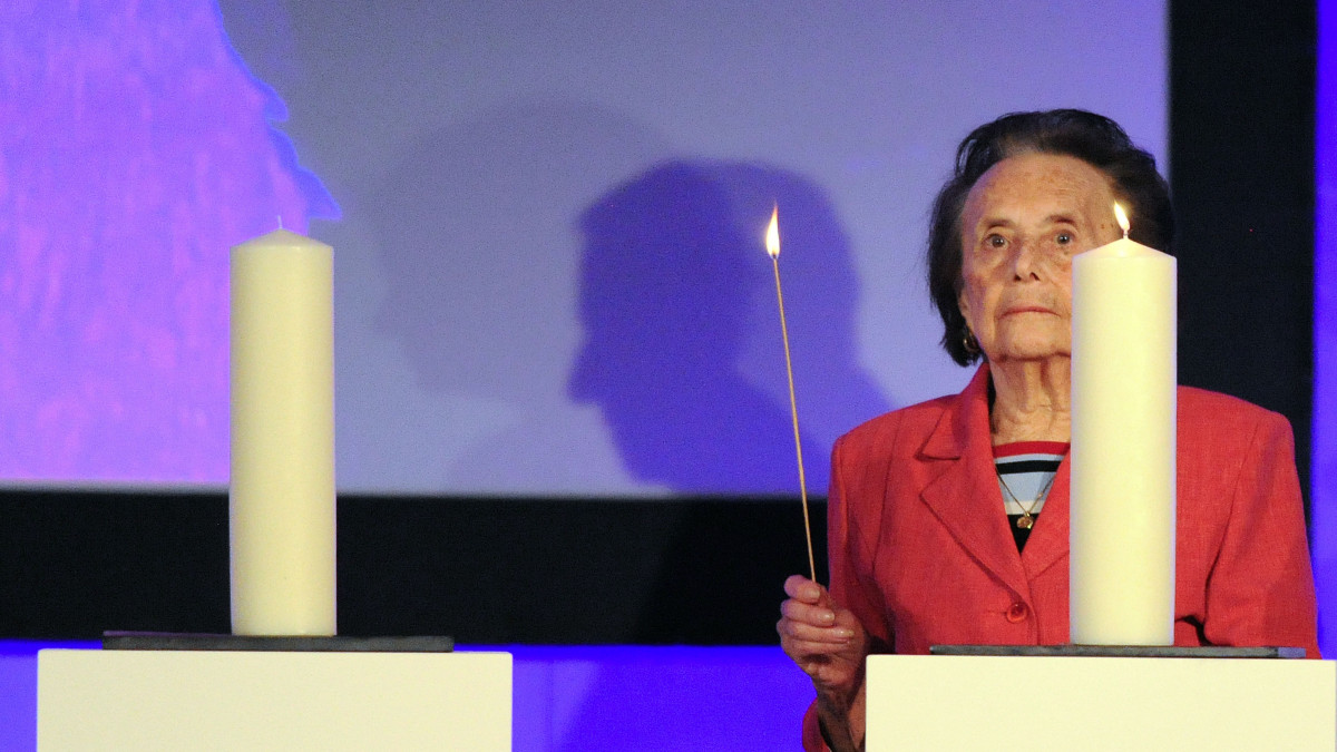 Holocaust survivor Lily Ebert stands by a candle she lit during a Holocaust Memorial Day service at the QEII Conference Centre in central London. (Photo by Nick Ansell/PA Images via Getty Images)