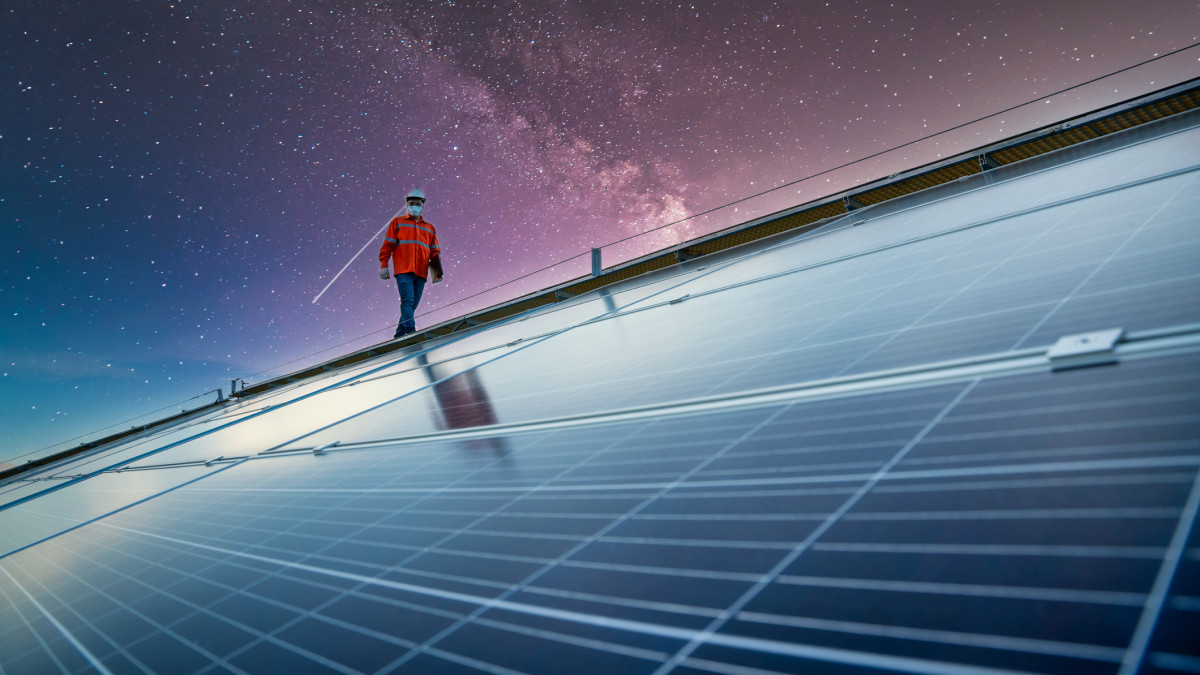 engineer working on checking equipment in solar power plant on the roof, Solar energy technology concept  and The energy concept of the universe and galaxies
