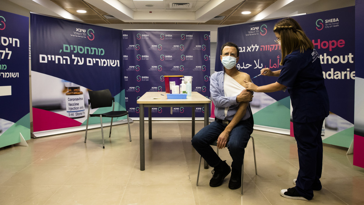 RAMAT GAN, ISRAEL - DECEMBER 31:  Heart transplant patient, Nimrod Amami, receives  a fourth dose of coronavirus (COVID-19) disease vaccine on December 31, 2021 in Ramat Gan, Israel. Israels Health Ministry approves a fourth vaccine dose for people with compromised immune systems.  (Photo by Amir Levy/Getty Images)