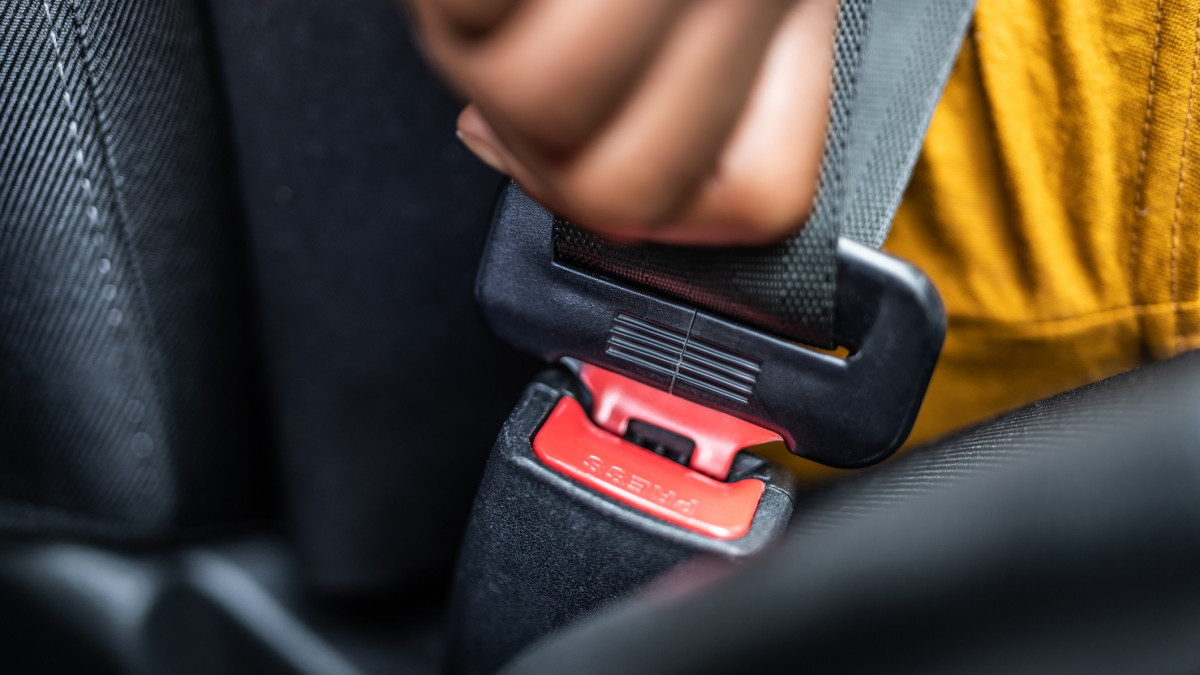 African Woman Buckling Up Seatbelt To Drive Car Safely