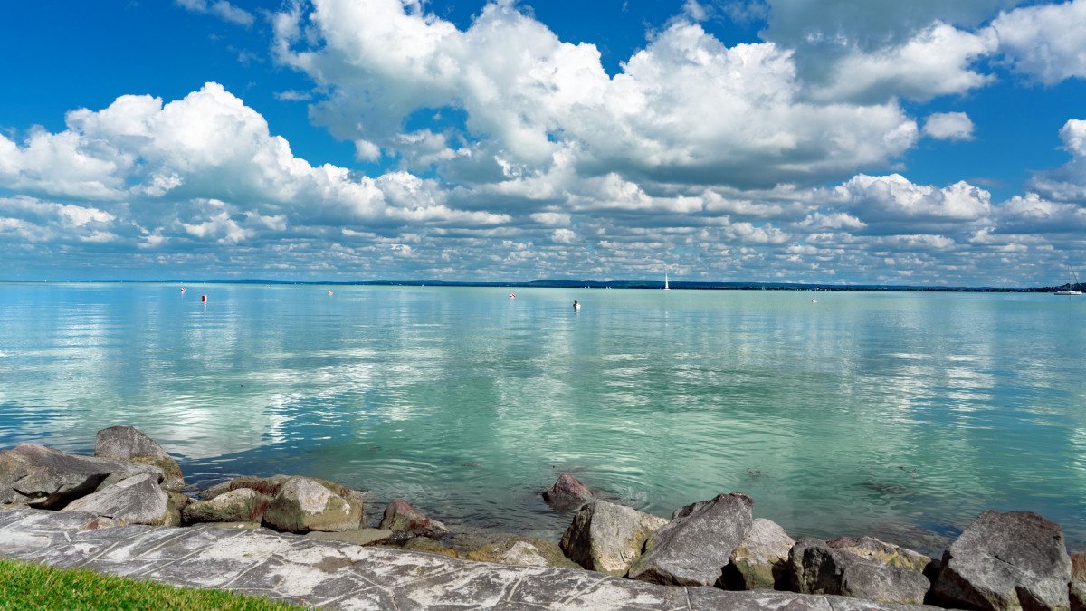 simple picture about Lake Balaton in Hungary from Badacsony beach with blue sky and cloud refletion on the water .