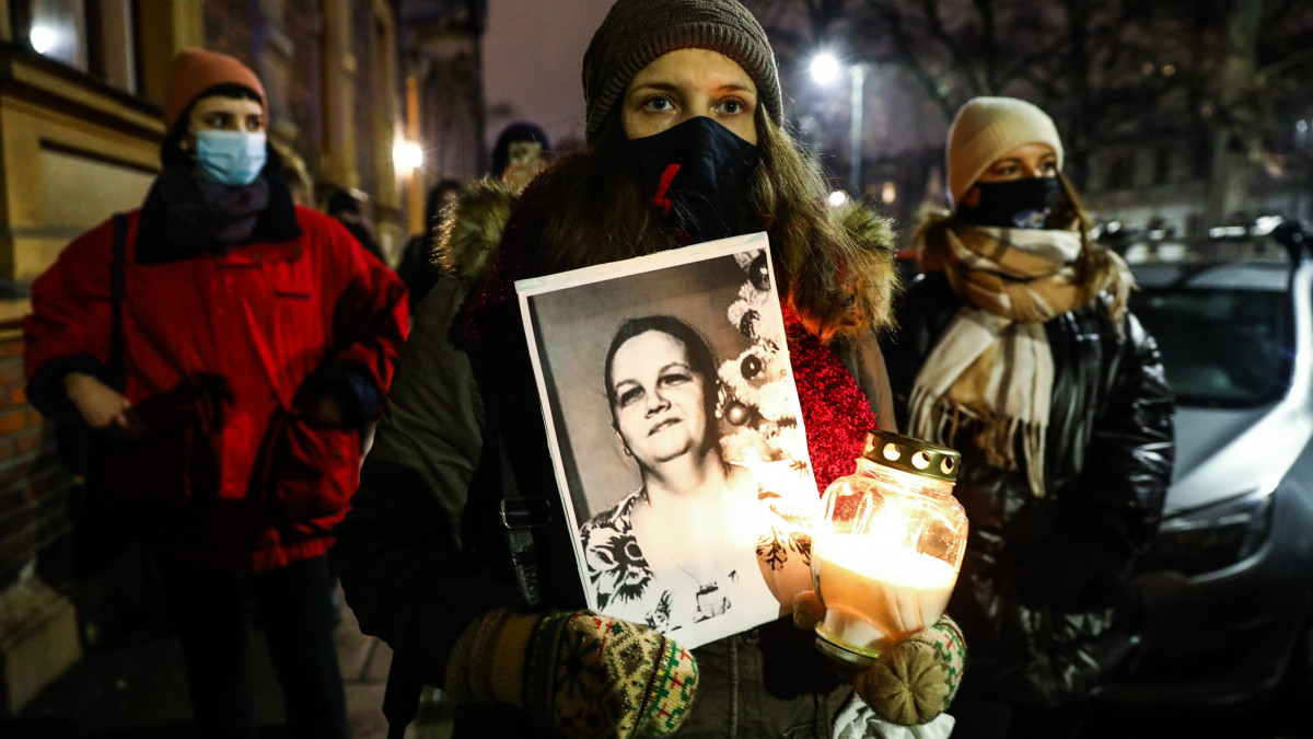A picture of a deceased woman, named Agnieszka, is hold during a protest in front of the Law and Justice (PiS) ruling party office against the abortion ban. Krakow, Poland on January 26, 2022. Agnieszka, a 37-year-old woman pregnant with twins, died on January 25th after she was admitted to the hospital in Czestochowa, where the first of her sons died on December 23. The pregnancy was terminated only on December 31, despite the death of the second foetus had been pronounced earlier. (Photo by Beata Zawrzel/NurPhoto via Getty Images)