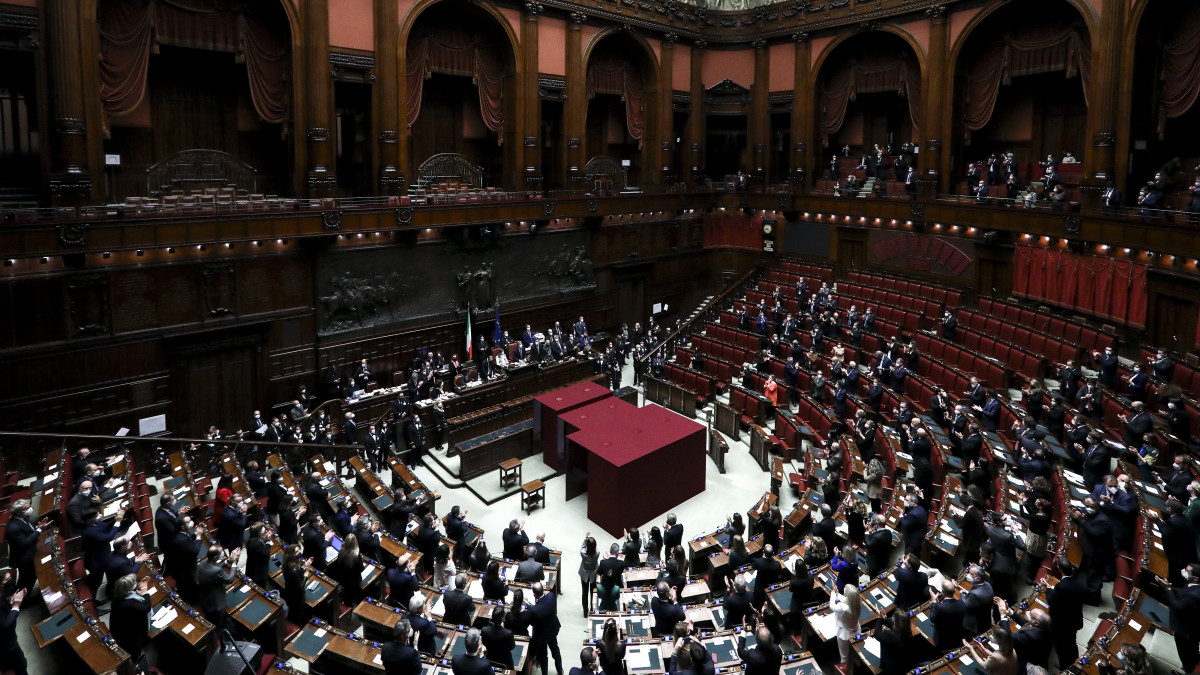 Members of Italys parliament stand to applaud after a quorum was reached during the eighth round of voting to name a new president at the Chambers of Deputies in Rome, Italy, on Saturday, Jan. 29, 2022. Sergio MattarellaÂ was re-elected as Italys president, offering relief to investors by setting up former European Central Bank headÂ Mario DraghiÂ to remain prime minister. Photographer: Alessia Pierdomenico/Bloomberg via Getty Images