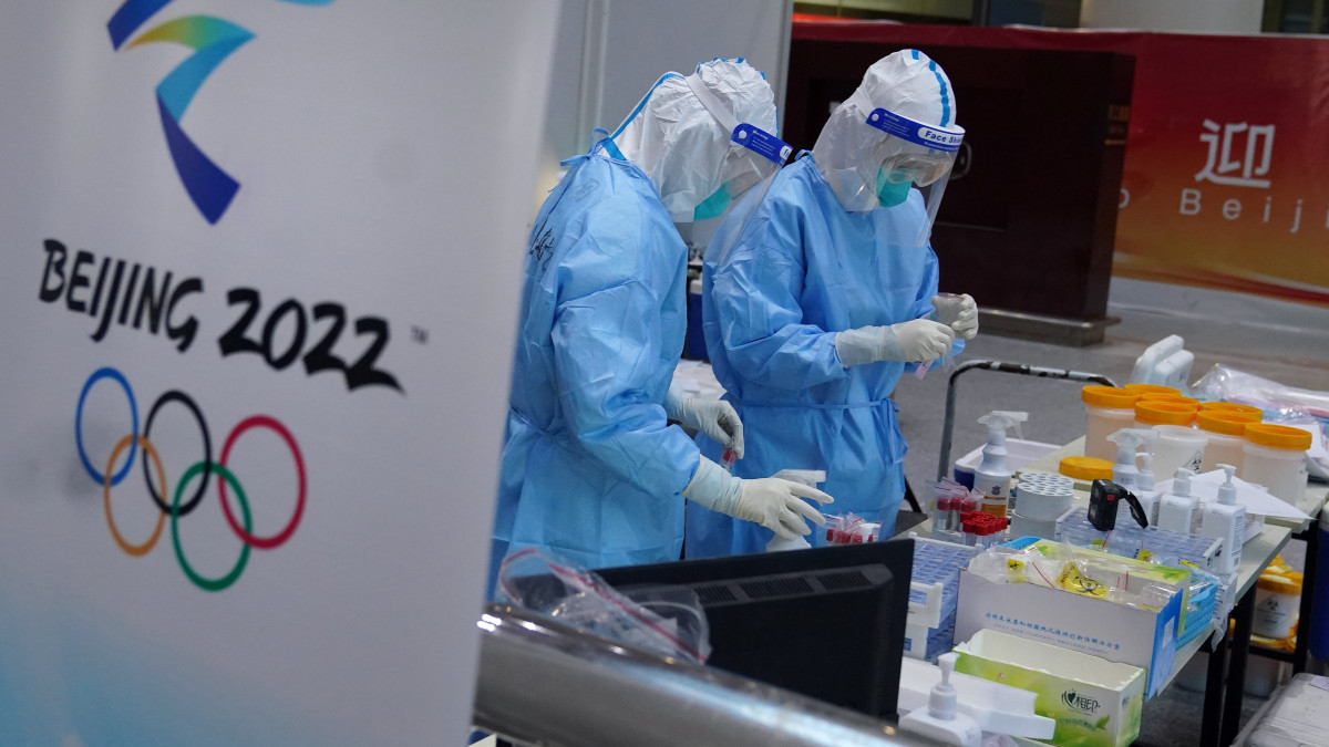 PCR testing staff wearing hazmat suits work at a PCR testing site at Beijing International Airport as passengers disembark a flight after arriving ahead of the Beijing 2022 Winter Olympic Games in China. Picture date: Monday January 31, 2022. (Photo by Andrew Milligan/PA Images via Getty Images)