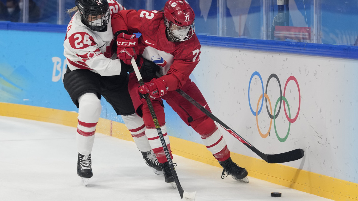 A kanadai Natalie Spooner (24) és az orosz Anna Savonyina (72) a 2022-es téli olimpia női jégkorongtorna A csoportjában játszott Orosz csapat-Kanada mérkőzésen a pekingi Nemzeti Fedett Stadionban 2022. február 7-én.