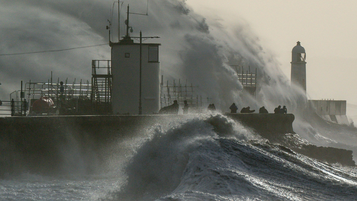 Waves crash against the sea wall and Porthcawl Lighthouse in Porthcawl, Bridgend, Wales, as Storm Eunice hits the south coast, with attractions closing, travel disruption and a major incident declared in some areas, meaning people are warned to stay indoors. Picture date: Friday February 18, 2022. (Photo by Jacob King/PA Images via Getty Images)