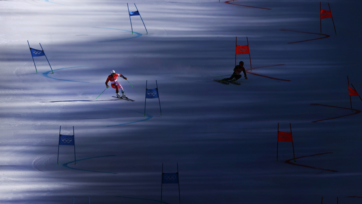 YANQING, CHINA - FEBRUARY 20:  Justin Murisier of Team Switzerland (L) skis during the Mixed Team Parallel heats on day 16 of the Beijing 2022 Winter Olympic Games at National Alpine Ski Centre on February 20, 2022 in Yanqing, China. (Photo by Alex Pantling/Getty Images)