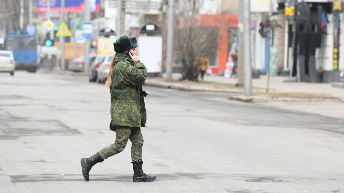 DONETSK, UKRAINE - FEBRUARY 22: A female soldier walks in the streets of self-proclaimed so-called Donetsk Peoples Republic (DNR) after RussiaĂ˘s decision to recognize the Donetsk region as an independent state in Donetsk, Ukraine on February 22, 2022. (Photo by Stringer/Anadolu Agency via Getty Images)
