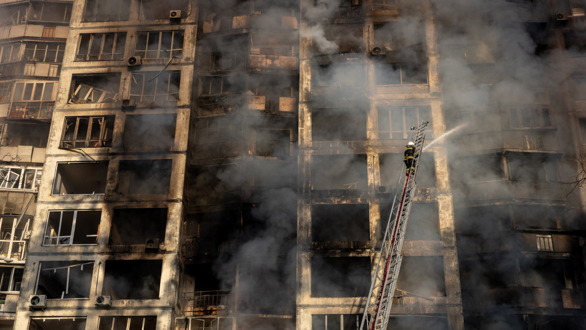 KYIV, UKRAINE - MARCH 15: Firefighters work to extinguish a fire at a residential apartment building in the Sviatoshynskyi District after it was hit by a Russian attack in the early hours of the morning  on March 15, 2022 in Kyiv, Ukraine. Russian forces continue to attempt to encircle the Ukrainian capital, although they have faced stiff resistance and logistical challenges since launching a large-scale invasion of Ukraine last month. Russian troops are advancing from the northwest and northeast of the city. (Photo by Chris McGrath/Getty Images)