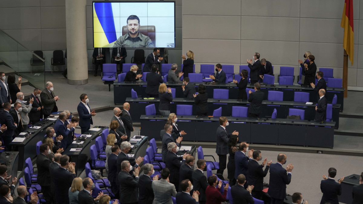 Volodimir Zelenszkij ukrán elnök (a kivetítőn) videókapcsolaton keresztül mond beszédet a német szövetségi parlament (Bundestag) ülésén Berlinben 2022. március 17-én. Vlagyimir Putyin orosz elnök február 24-én rendelte el katonai művelet végrehajtását Ukrajnában.