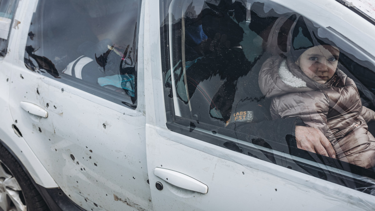 ZAPORIZHZHIA, UKRAINE - MARCH 30: People arrive in Zaporizhzhya with a a shrapnel-damaged car after they fled from Mariupol due to Russian attacks, on March 30, 2022 in Zaporizhzhya, Ukraine. (Photo by Diego Herrera Carcedo/Anadolu Agency via Getty Images)