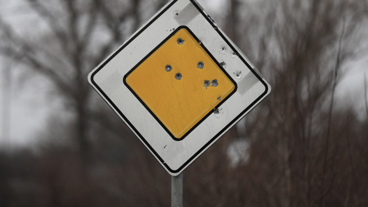 Golyó okozta lyukak egy útjelző táblán a Kijevi területen 2022. március 30-án.