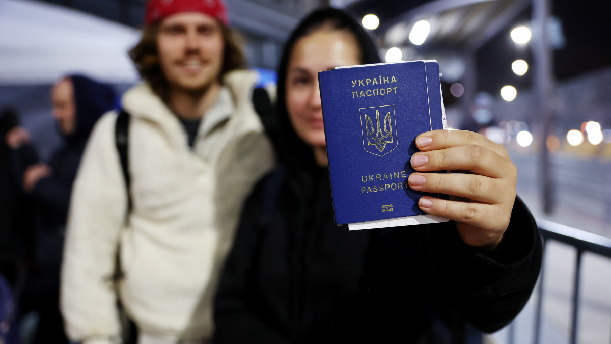 TIJUANA, MEXICO - APRIL 05: Ukrainian Sasha, who is seeking asylum in the U.S., displays her passport as she waits to cross the U.S.-Mexico border at the San Ysidro Port of Entry amid the Russian invasion of Ukraine on April 5, 2022 in Tijuana, Mexico. U.S. authorities are allowing Ukrainian refugees to enter the U.S. at the Southern border in Tijuana with permission to remain in the country on humanitarian parole for one year.  (Photo by Mario Tama/Getty Images)