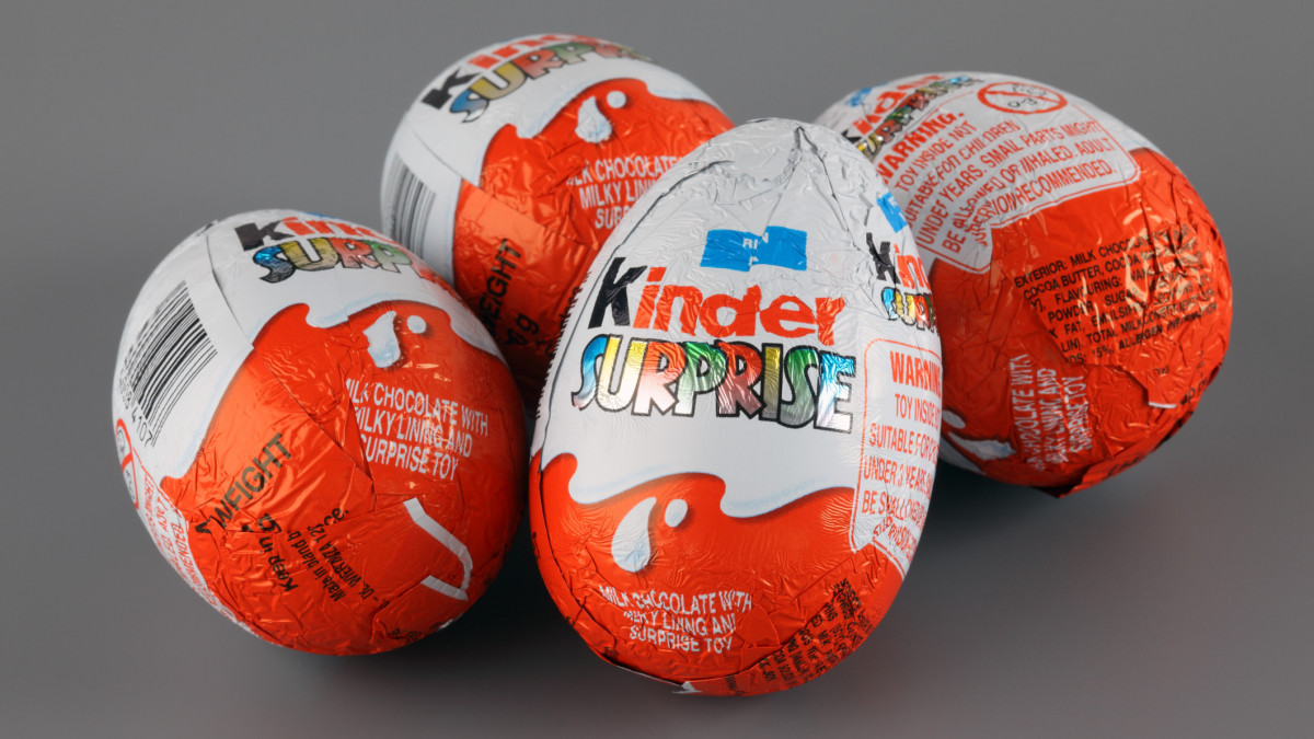 Tambov, Russian Federation - April 04, 2013: Four Kinder Surprise Eggs on grey background. Kinder Surprise manufactured by Italian company Ferrero. Studio Shot. Each Kinder Surprise egg consists of a chocolate shell, a plastic capsule, the contents of said capsule, and an external foil wrap.