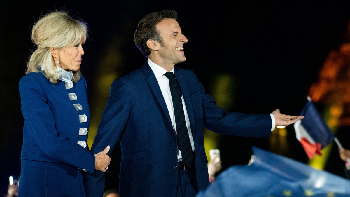 Emmanuel Macron, Frances president, right, and wife Brigitte Macron celebrate on stage following the second round of voting in the French presidential election in Paris, France, on Sunday, April 24, 2022. MacronÂ defeated far-right leaderÂ Marine Le PenÂ in the French presidential election on a pro-business, pro-European Union platform, bolstering the bloc in the midst of its worst security crisis in decades. Photographer: Benjamin Girette/Bloomberg via Getty Images