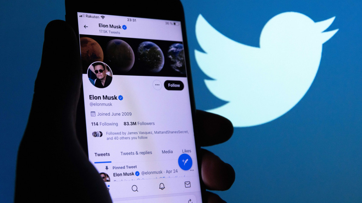 JAPAN - 2022/04/26: In this photo illustration, Elon Musks twitter account is seen displayed on a smartphone with a background of the twitter logo. Rumours have emerged that Twitter is seriously considering a buy-out proposal by Elon Musk. Twitters board is reportedly exploring Musks $43bn offer for a takeover of the social media platform. (Photo Illustration byStanislav Kogiku/SOPA Images/LightRocket via Getty Images)