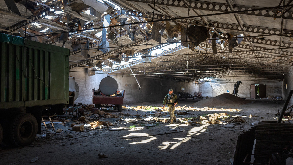 NOVOVORONTSOVKA, UKRAINE - MAY 06: A Ukrainian army officer inspects a grain warehouse earlier shelled by Russian forces on May 06, 2022 near the frontlines of Kherson Oblast in Novovorontsovka, Ukraine. Russia has been accused of targeting food storage sites in frontline areas and generally degrading Ukraines wheat production, potentially causing a global shortage. The regions provincial capital, Kherson, fell to Russia shortly after the Feb. 24 invasion, as Russia sought to create a land bridge between the Crimean peninsula and  the eastern Donbas region. (Photo by John Moore/Getty Images)