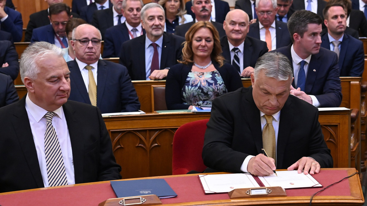 Orbán Viktor miniszterelnök (j) aláírja a kinevezési okmányokat eskütételét követően az Országgyűlés ülésén 2022. május 16-án. Mellette Semjén Zsolt miniszterelnök-helyettes.