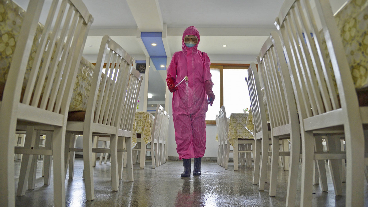 A worker disinfects a dining room at a sanitary supplies factory in Pyongyang on May 16, 2022, amid growing fears over the spread of COVID-19.  (Photo by Kyodo News via Getty Images)
