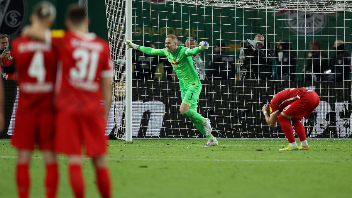 BERLIN, GERMANY - MAY 21: Peter Gulacsi of RB Leipzig celebrates after Ermedin Demirovic of SC Freiburg missed the decisive penalty in the penalty shoot out during the final match of the DFB Cup 2022 between SC Freiburg and RB Leipzig at Olympiastadion on May 21, 2022 in Berlin, Germany. (Photo by Alex Grimm/Getty Images)